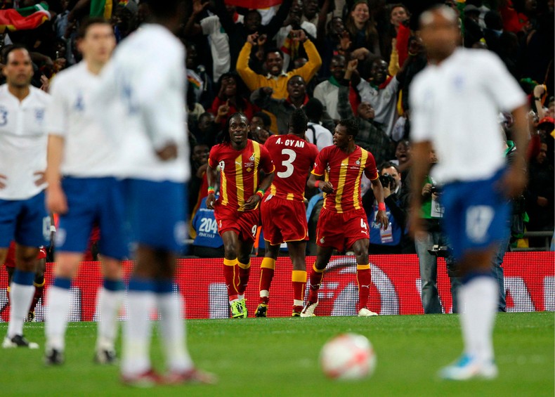 Asamoah Gyan celebrates after scoring against England in friendly