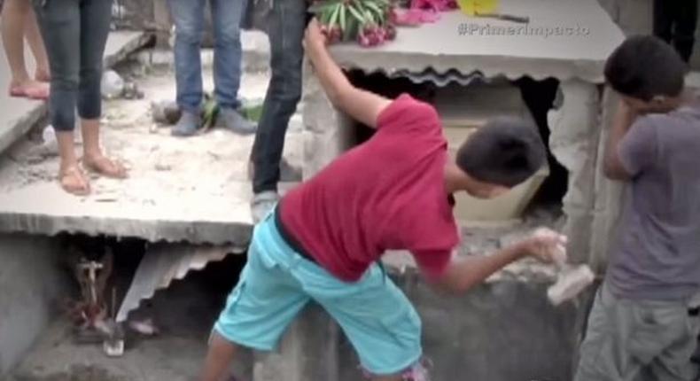 Relatives of the deceased smashing into her tomb after claiming to hear her screaming for help 