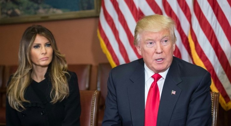 Melania Trump (L) listens to her husband US President-elect Donald Trump speak to the press at the US Capitol on November 10, 2016