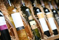 Closeup shot of wineshelf. Bottles lay over straw.