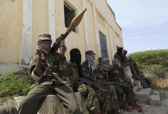 Al Shabaab soldiers sit outside a building during patrol along the streets of Dayniile district in Southern Mogadishu, March 5, 2012. Photo Credit: Reuters