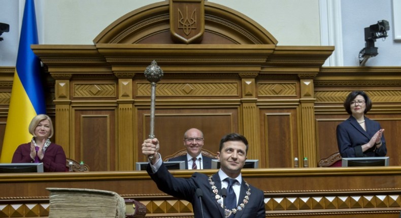 Ukraine's President Volodymyr Zelensky holds the Bulava, the Ukrainian symbol of power, during his inauguration ceremony at the parliament in Kiev on the same day that Russia wanted to convene a UN Security Council meeting on Ukraine's language law