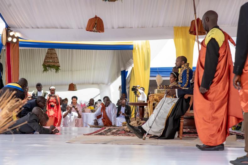 Subject prostrate before King Oyo and the Queen Mother Best Kemigisa