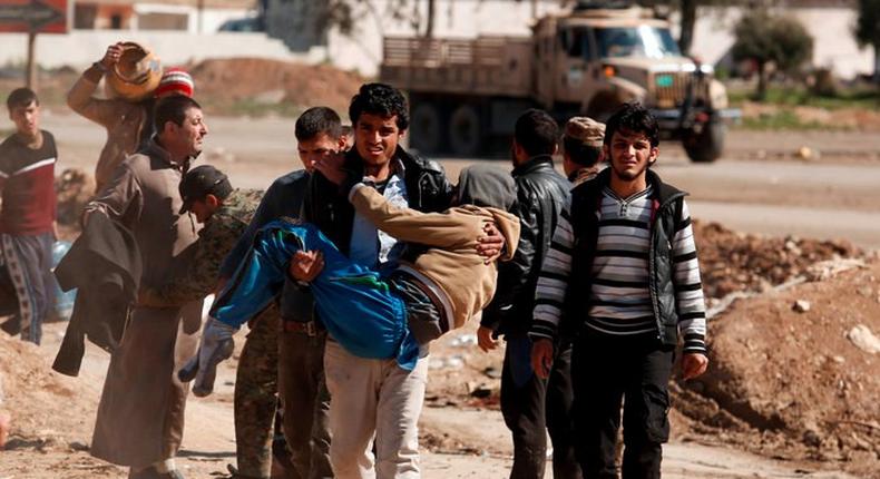 Displaced people are checked by Iraqi forces as Iraqi forces battle with ISIS militants in western Mosul.