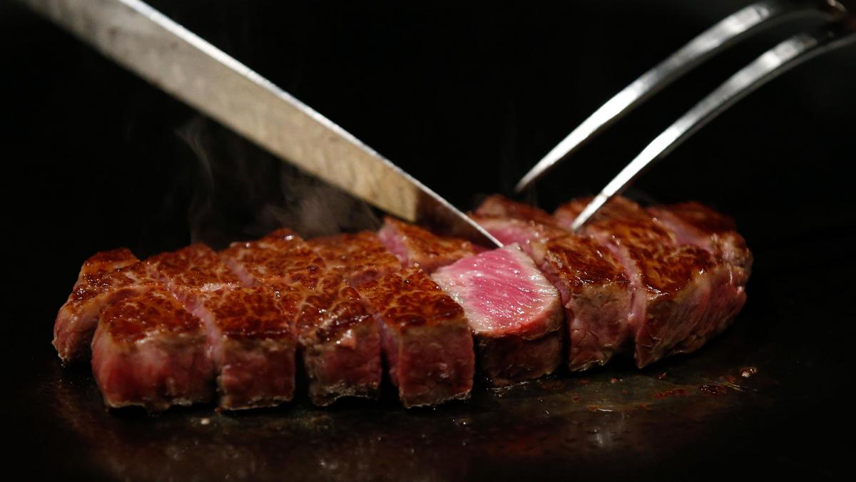 A chef cuts highest award winning female Kobe beef, which is priced 210,000 yen ($2040) per 1kg, at 