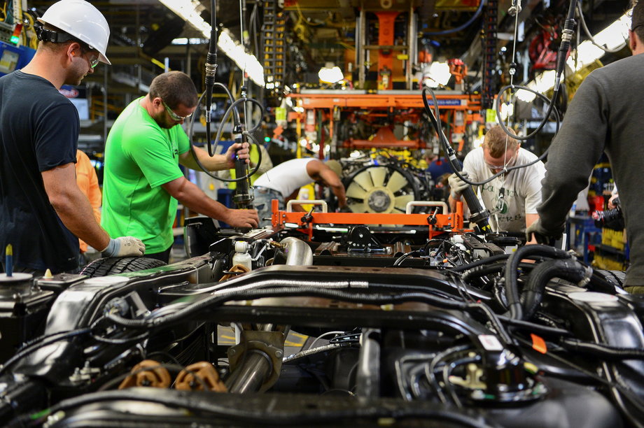 Workers assemble a Ford truck.