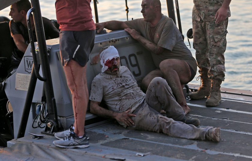 Damaged vehicle and buildings are pictured near the site of Tuesday's blast in Beirut's port area