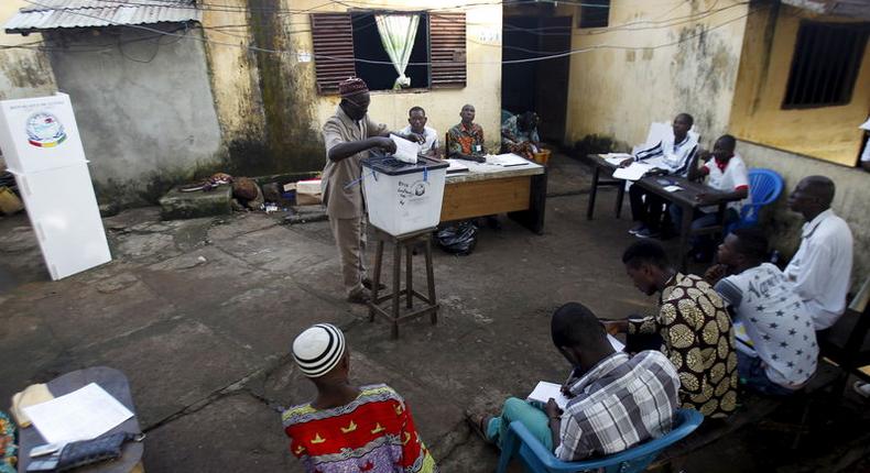 A man casts his vote at a polling station during a presidential election in Conakry, Guinea October 11, 2015. REUTERS/Luc Gnago