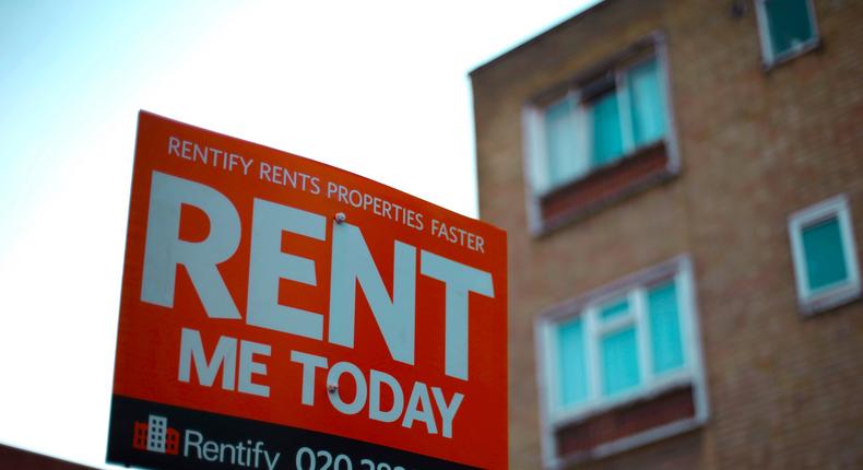 A letting agent sign displaying 'rent me today' outside flats in north London.