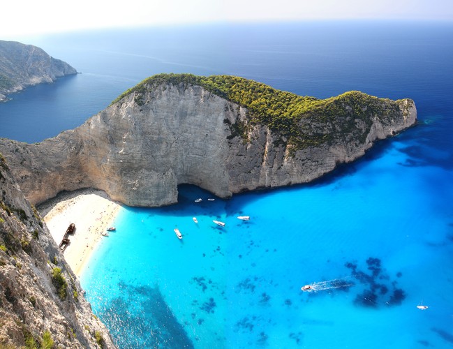 Zakynthos<br><br>Poniższe zdjęcie miałeś/miałaś szansę już widzieć. Plaża Navagio na wyspie Zakyntos to prawdopodobnie najbardziej fotografowane miejsce w Grecji. Okręt, którego wrak spoczywa dziś w zatoce, dawnej służył do przemytu cennych dóbr. Inne piękne plaże, którymi może pochwalić się wyspa to Gerakas, którą upatrzyły sobie żółwie do składania jaj i Tsilivi, wymarzona do uprawiania sportów wodych.