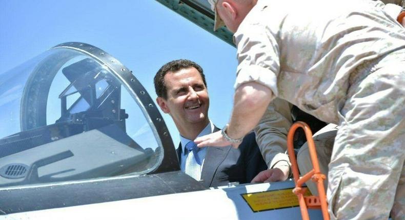 A handout picture released by the Syrian presidency on June 27, 2017 shows President Bashar al-Assad inside an Su-27 fighter jet during a visit to the Hmeimim military base in Latakia province