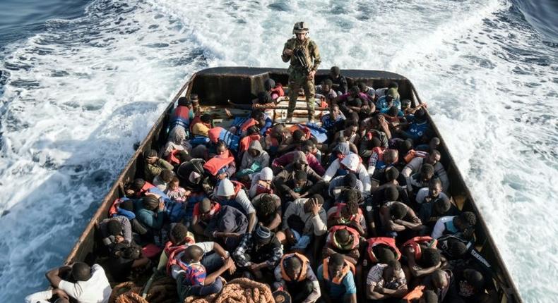 A Libyan coastguard guards some of 147 migrants rescued attempting to reach Europe on June 27, 2017