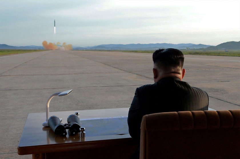 FILE PHOTO: North Korean leader Kim Jong Un watches the launch of a Hwasong-12 missile in this undat