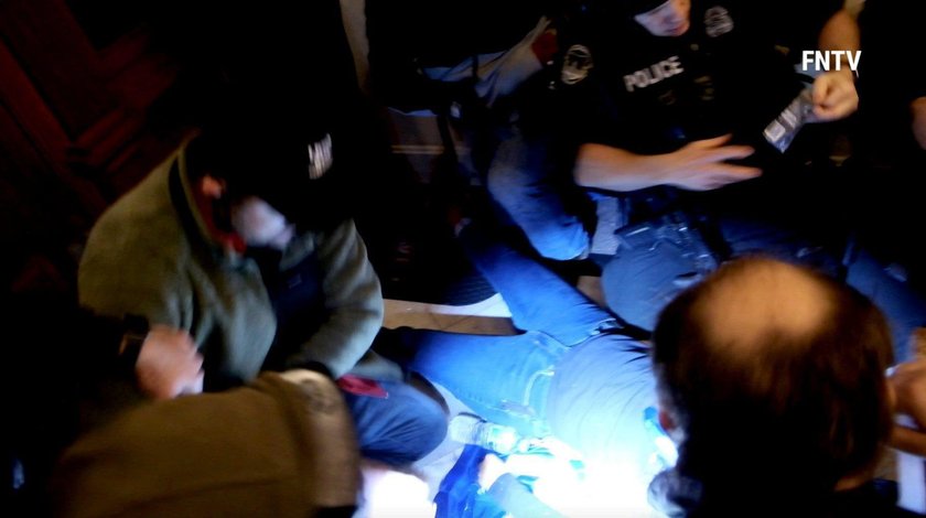 People and police help a woman, who was shot, as she lies on the floor, after supporters of U.S. Pre