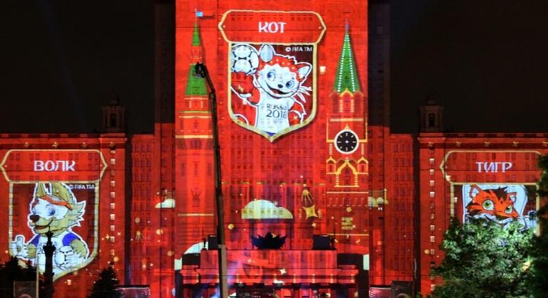 Pictures of candidates for the official mascot of the 2018 FIFA World Cup in Russia, including (L-R) a wolf, a cat and a tiger, are projected onto Moscow State University