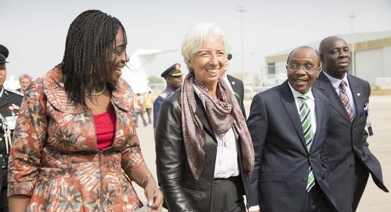 International Monetary Fund Managing (IMF) Director Christine Lagarde (C) is escorted by Nigeria's Finance Minister Kemi Adeosun (L) and Nigeria's Central Bank Governor Godwin Emefiele (2nd R) upon arriving at the Nnamdi Azikiwe International Airport in Abuja, Nigeria, January 4, 2016. REUTERS/IMF Staff Photo/Stephen Jaffe/HandoutA