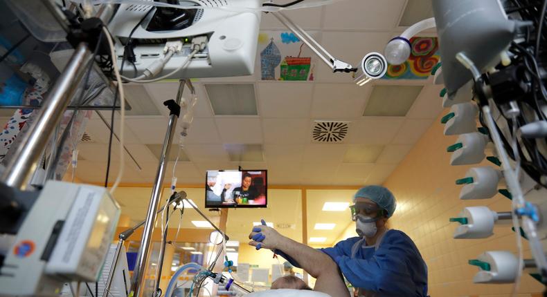 A healthcare worker attends to a COVID-19 patient in an intensive care unit in Prague, Czech Republic.