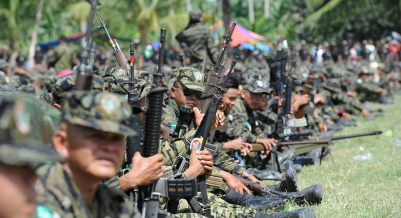 Moro Islamic Liberation Front (MILF) rebels gather inside their camp, as thousands of its members and residents arrive for a rally in support of the peace in 2014