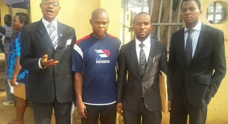 Joachim Ike surrounded by his lawyers