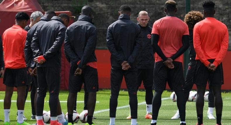 Manchester United players observe a minute's silence for the victims of yesterday's terror attack at the Manchester Arena, during a training session at the club's training complex near Carrington, on May 23, 2017