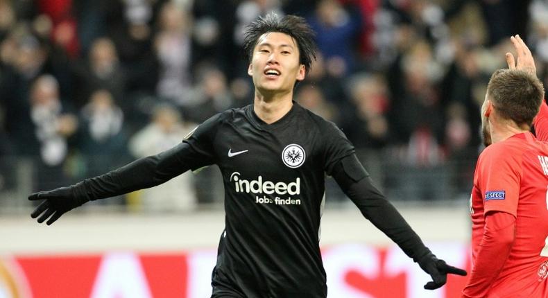 Frankfurt's Japanese midfielder Daichi Kamada celebrates scoring the 2-0 past Salzburg's Austrian goalkeeper Cican Stankovic during the Europa League last 32 first leg football match between Eintracht Frankfurt and Salzburg in Frankfurt am Main on February 20, 2020.