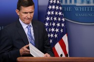 National security adviser General Michael Flynn (L) arrives to deliver a statement next to Press Sec