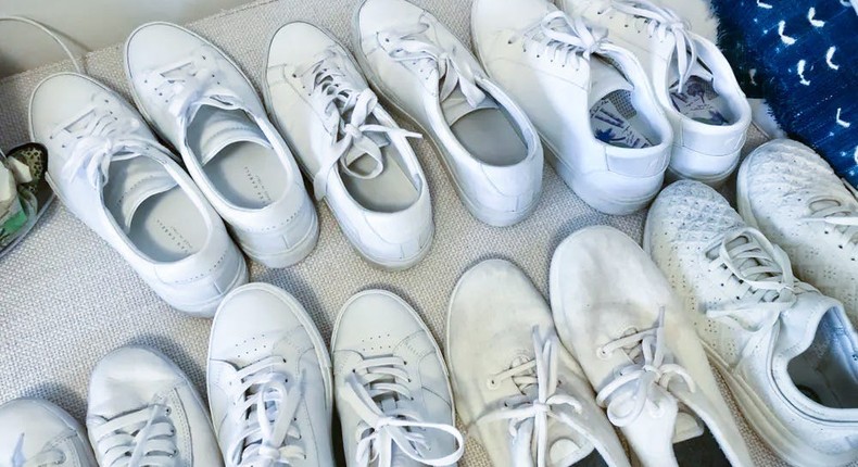 Rows of white shoes lined up to be tested as part of our roundup of the best white sneakers for women.
