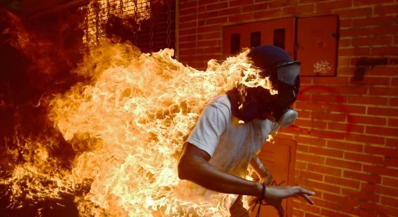 A demonstrator catches fire during clashes with riot police within a protest against Venezuelan President Nicolas Maduro, in Caracas on May 3, 2017