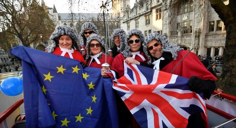 Members of the pro-European movement Britain for Europe pose outside the Supreme Court building in London on December 5, 2016