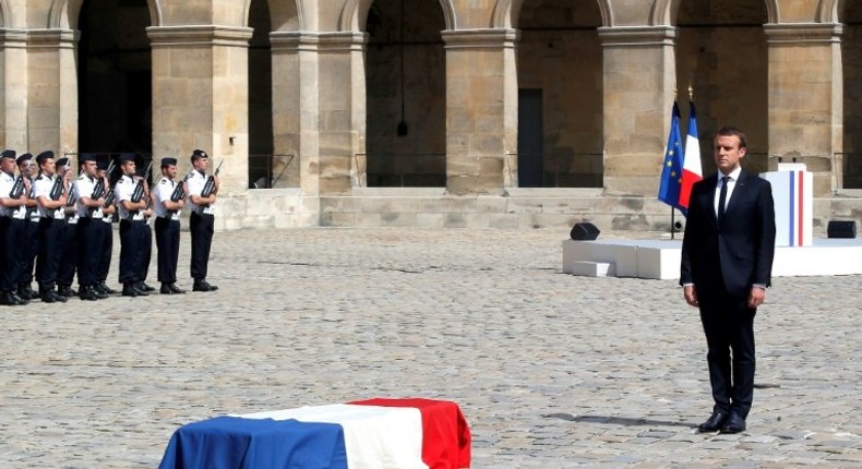 French President Emmanuel Macron pays his respects to the flag-draped coffin of Holocaust survivor Simone Veil, during a tribute ceremony at the Invalides in Paris, on July 5, 2017