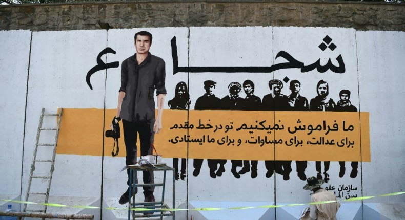 AFP's chief photographer in Afghanistan, Shah Marai, depicted on a mural in Kabul, was among 25 people killed along with eight other journalists, in an April bomb attack