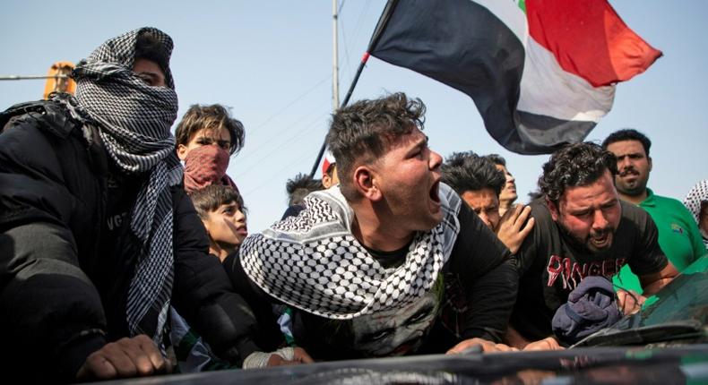 Angry Iraqi demonstrators mourn the killing of female activist and paramedic Janat Madhi, in Basra on Tuesday night, part of an upsurge of violence against the three-month-old protest movement