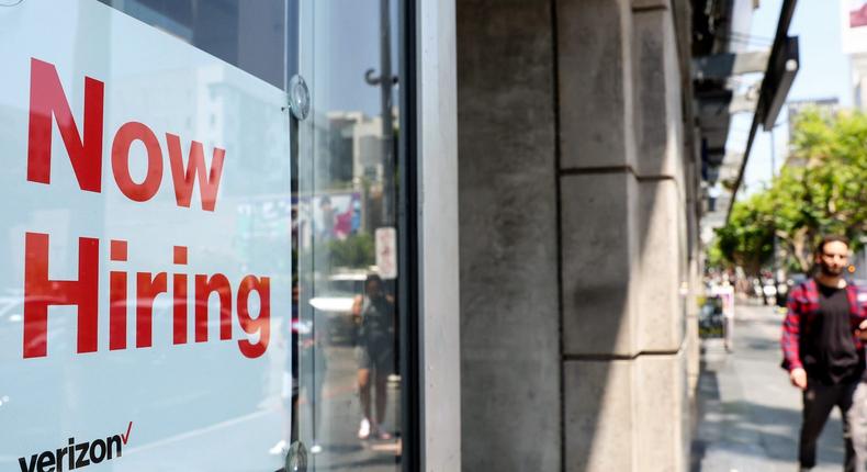 A 'Now Hiring' sign is posted at a Verizon store on July 26, 2022 in Los Angeles, California.Mario Tama/Getty Images