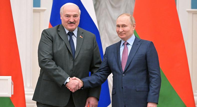 Russia's President Vladimir Putin (R) shakes hands with his Belarus counterpart Alexander Lukashenko (L) during a press conference following their talks at the Kremlin in Moscow on February 18, 2022.