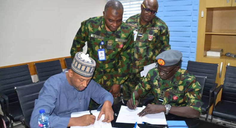Chief of the Air Staff (CAS), Air Marshal Hasan Abubakar, signing agreement on Group Personal Accident Insurance Policy (GPAIP) with KBC Insurance Brokers Limited in Abuja [NAN]