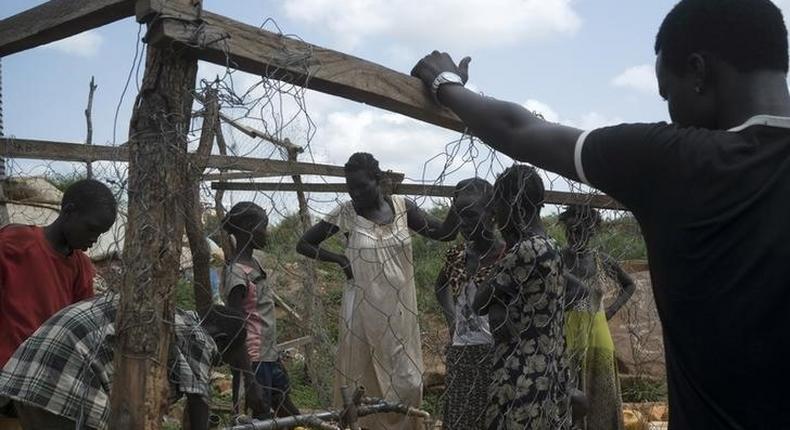 South Sudanese women collect water in the United Nations protection of civilians site hosting about 30,000 people displaced during the recent fighting in Juba, South Sudan, July 22, 2016. 