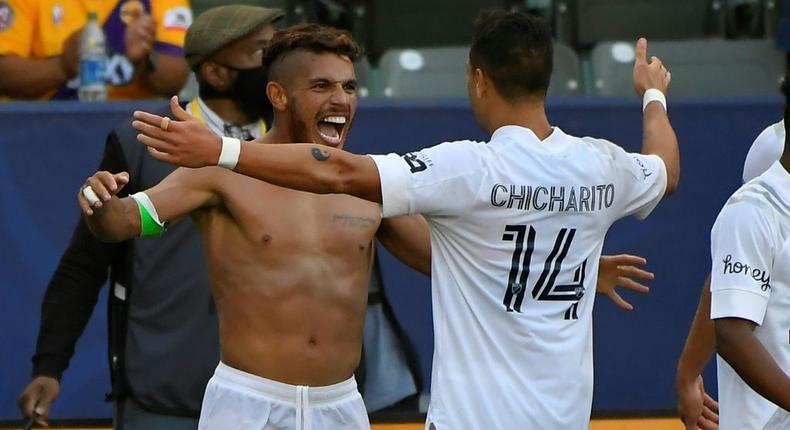 Shirtless  Jonathan dos Santos is congratulated by Los Angeles Galaxy teammate Javier Hernandez after scoring in the Galaxy's 2-1 Major League Soccer victory over Los Angeles FC Creator: John MCCOY