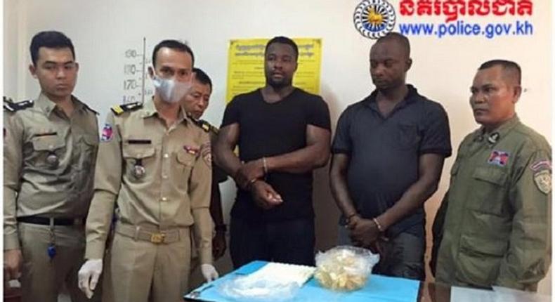 The suspects, Anthony Ifeanyi Okafor and Paschal Adibe with Cambodian police officials