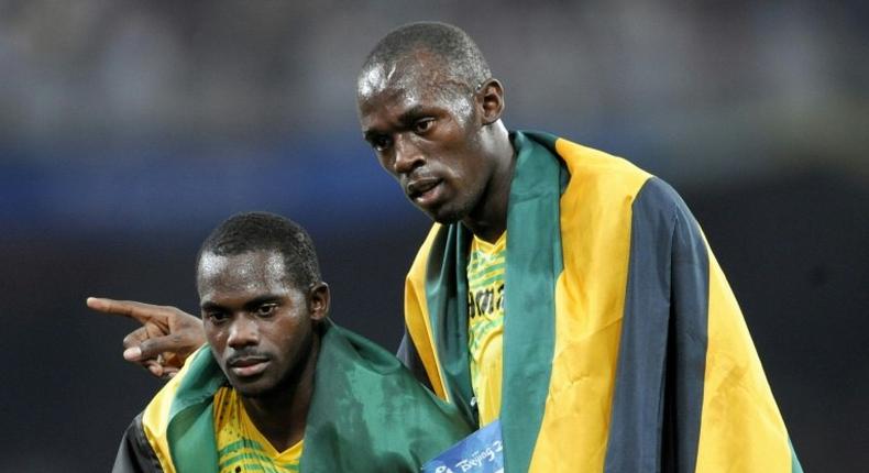 Jamaica's Nesta Carter (L), who tested positive for a banned substance, and Usain Bolt (R) were teammates in the men's 4×100m relay final during the 2008 Beijing Olympic Games, where they won gold