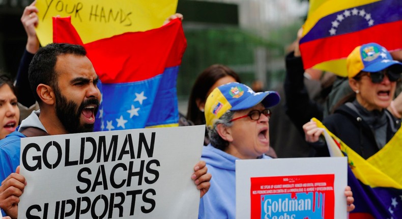 Protesters demonstrate outside of Goldman Sachs headquarters after the company purchased Venezuelan bonds in New York, U.S., May 30, 2017.