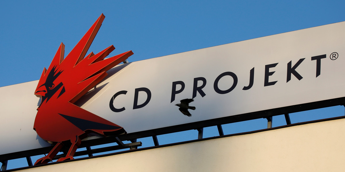 A bird flies in front of the Cd Projekt logo at its headquarters in Warsaw