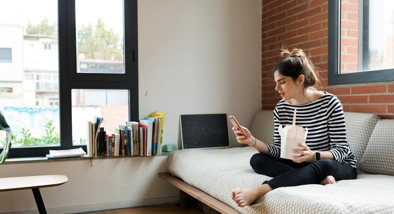 woman eating takeout at home