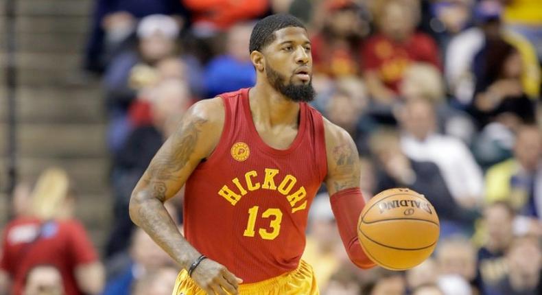 Paul George of the Indiana Pacers dribbles the ball against the Milwaukee Bucks at Bankers Life Fieldhouse on April 6, 2017