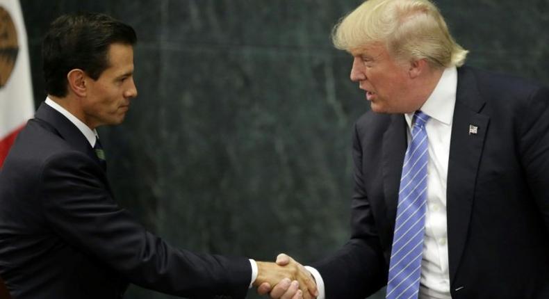 Mexican President Enrique Pena Nieto (L) and US presidential candidate Donald Trump shake hands after a meeting in Mexico City on August 31, 2016