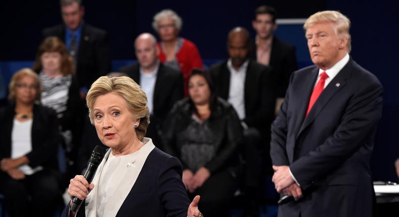 Democratic presidential nominee Hillary Clinton, left, talks as Republican presidential nominee Donald Trump listens during the second presidential debate at Washington University in St. Louis, Sunday, Oct. 9, 2016. (Saul Loeb/Pool via AP)