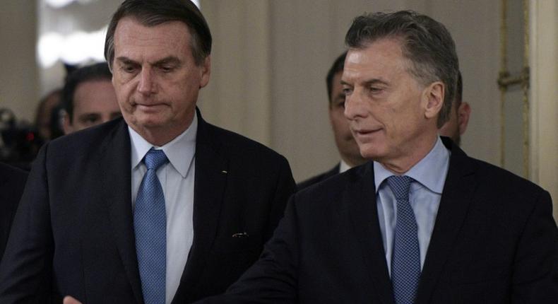 Brazilian President Jair Bolsonaro (L) and Argentine President Mauricio Macri arrive at a welcoming ceremony before holding a working meeting in Buenos Aires