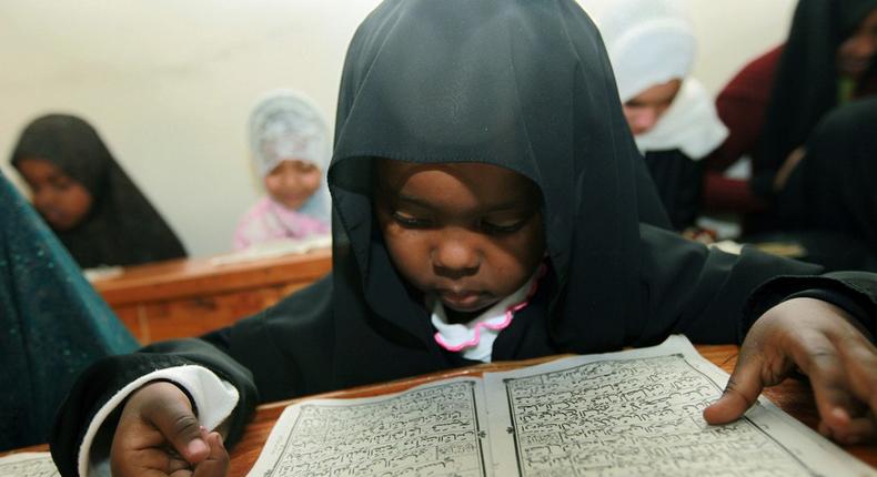 A Kenyan child reads verses from the Quran on the fifth day of the Muslim holy month of Ramadan in a Madrassa in Nairobi, Kenya on Wednesday, Aug. 26, 2009.