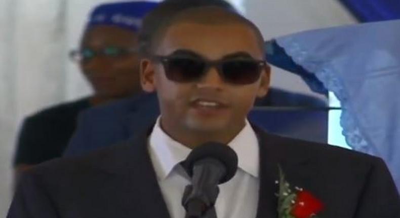 Andrew Kenneth lights up mourners at his grandmother, Rahab Muhuni's burial in Kirwara Gatundu