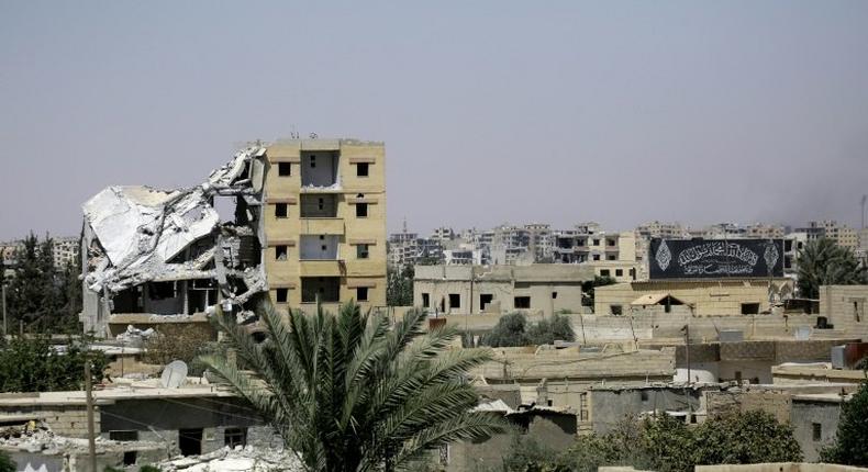 Damaged buildings in Raqa's western al-Darya neighbourhood, pictured on August 14, 2017 as Syrian Democratic Forces (SDF), a US backed Kurdish-Arab alliance, battle to retake the city from the Islamic State (IS) group