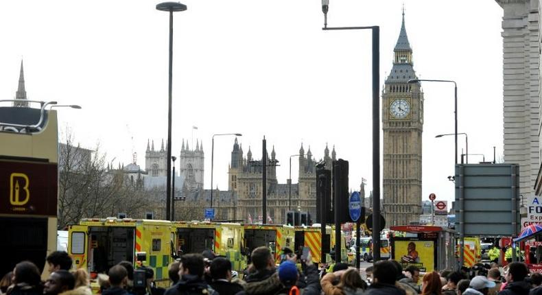 Members of the emergency services work on Westminster Bridge, alongside the Houses of Parliament in central London on March 22, 2017